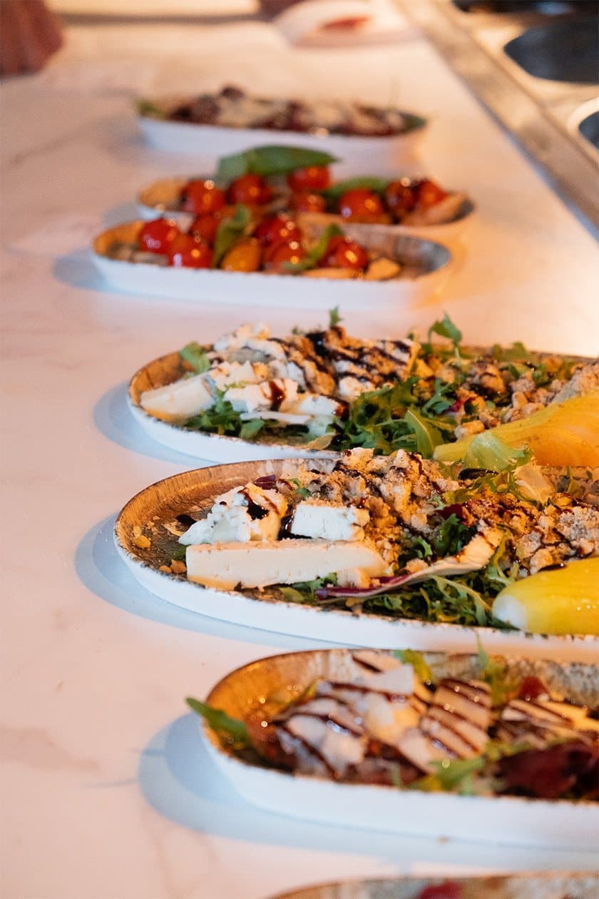 A row of antipasti plates dressed and ready to leave the pass