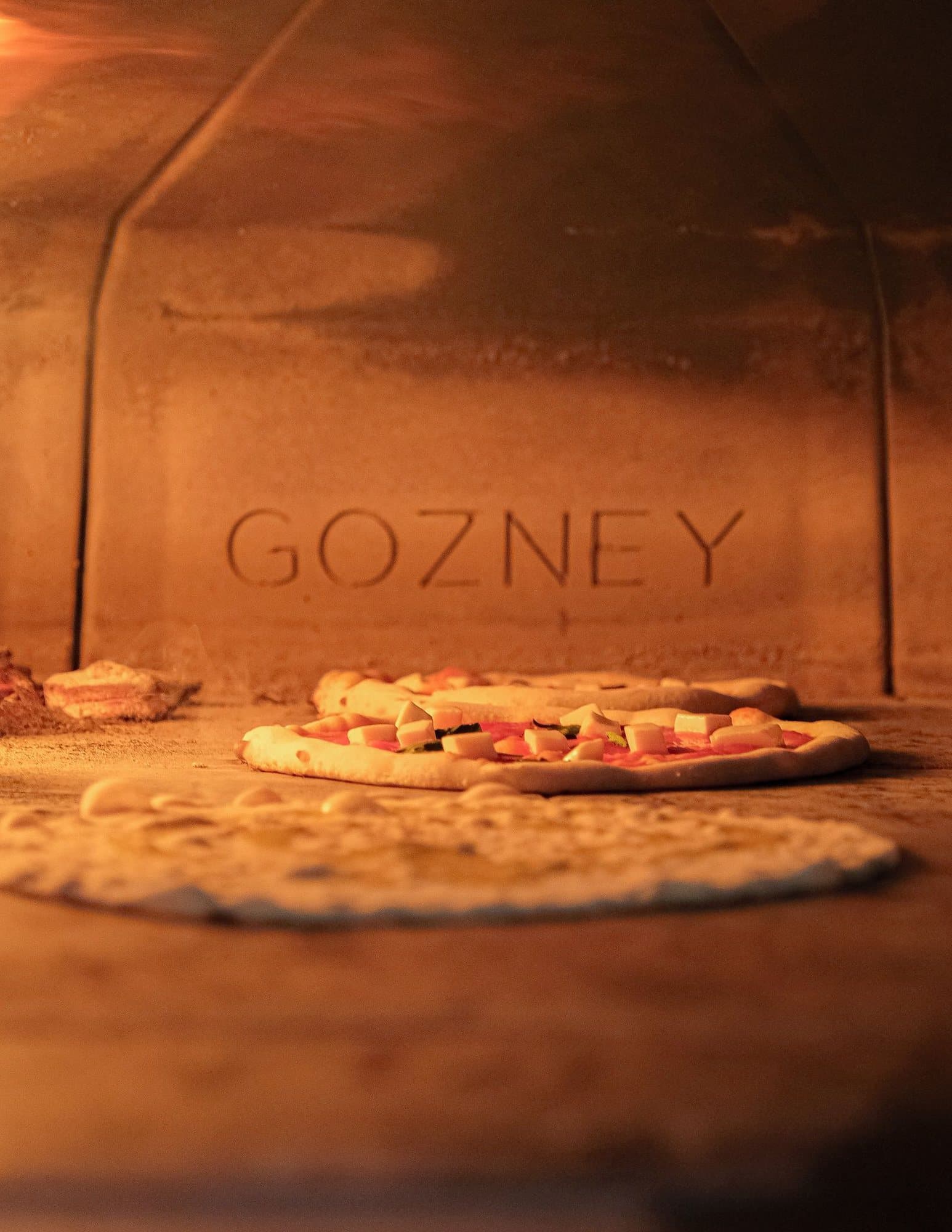 The glowing mouth of the wood-fired oven at Lacco