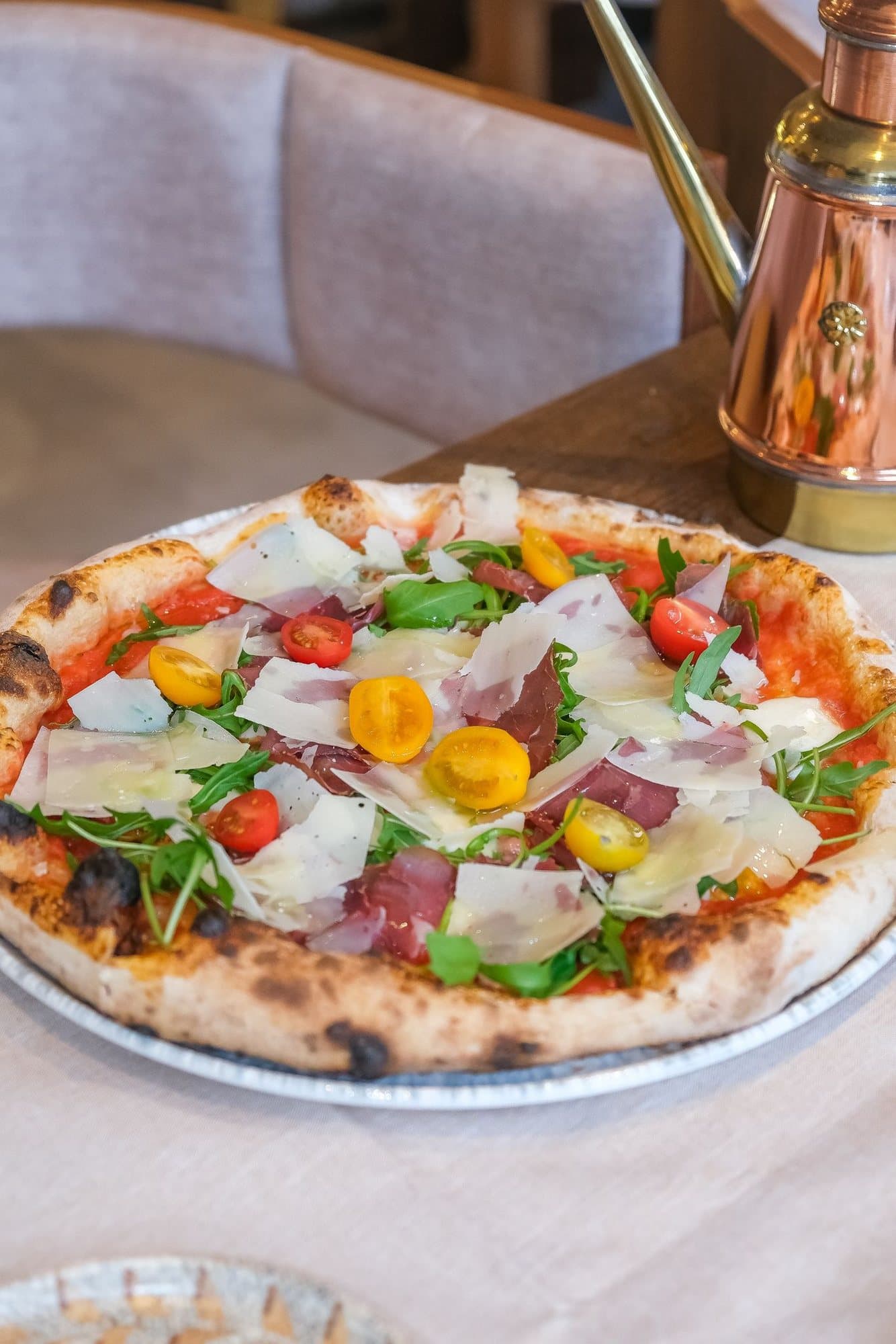 Smoked beef pizza with rocket, grana padano and baby tomatoes