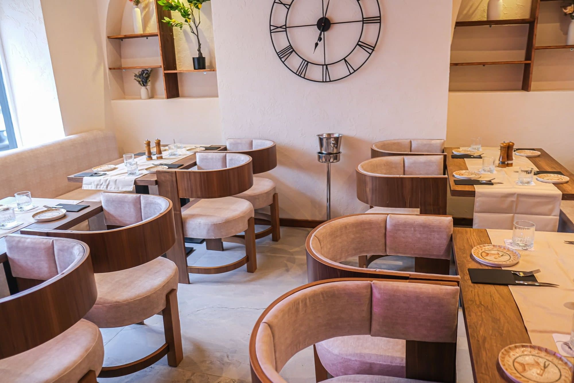 Dining room with the wall clock and pale timber chairs