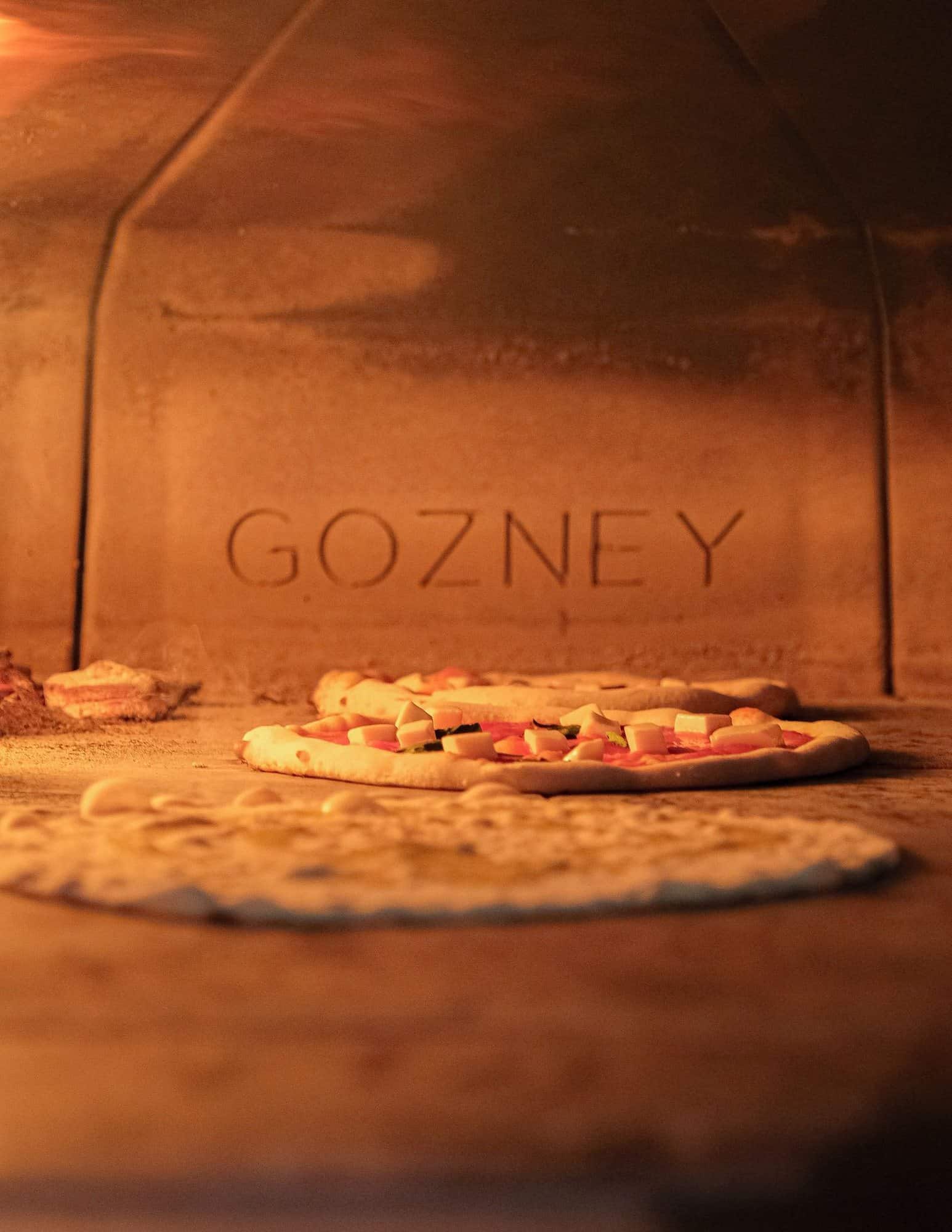 The glowing mouth of the wood-fired oven at Lacco